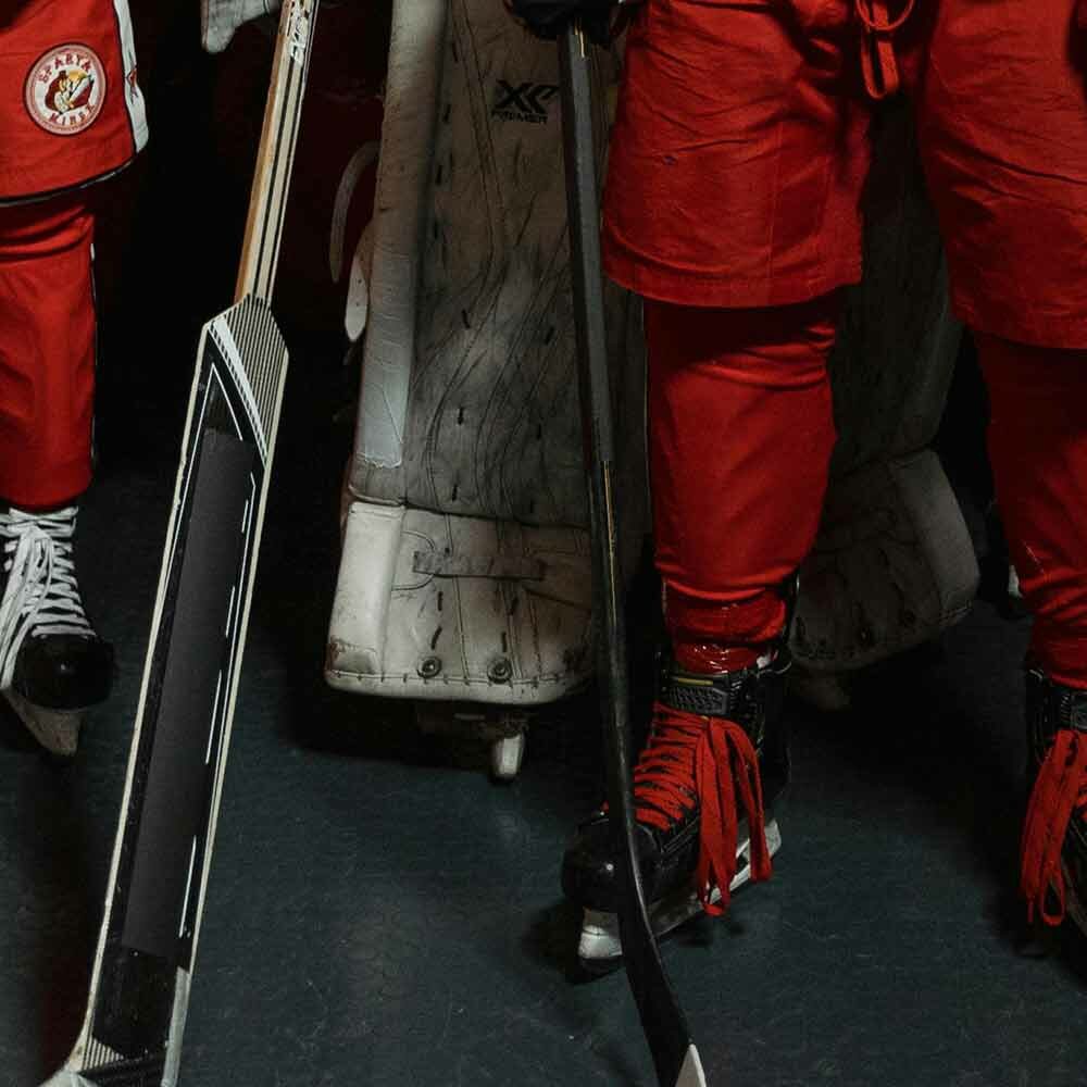 hockey players dressed for action as they exit the locker room